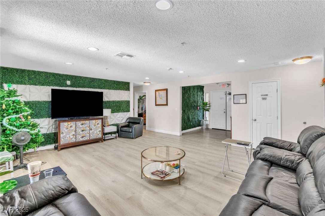 465 East Robindale Road Las Vegas, NV 89123 - Photo 27 of 32 Living room featuring wood finished floors, a text