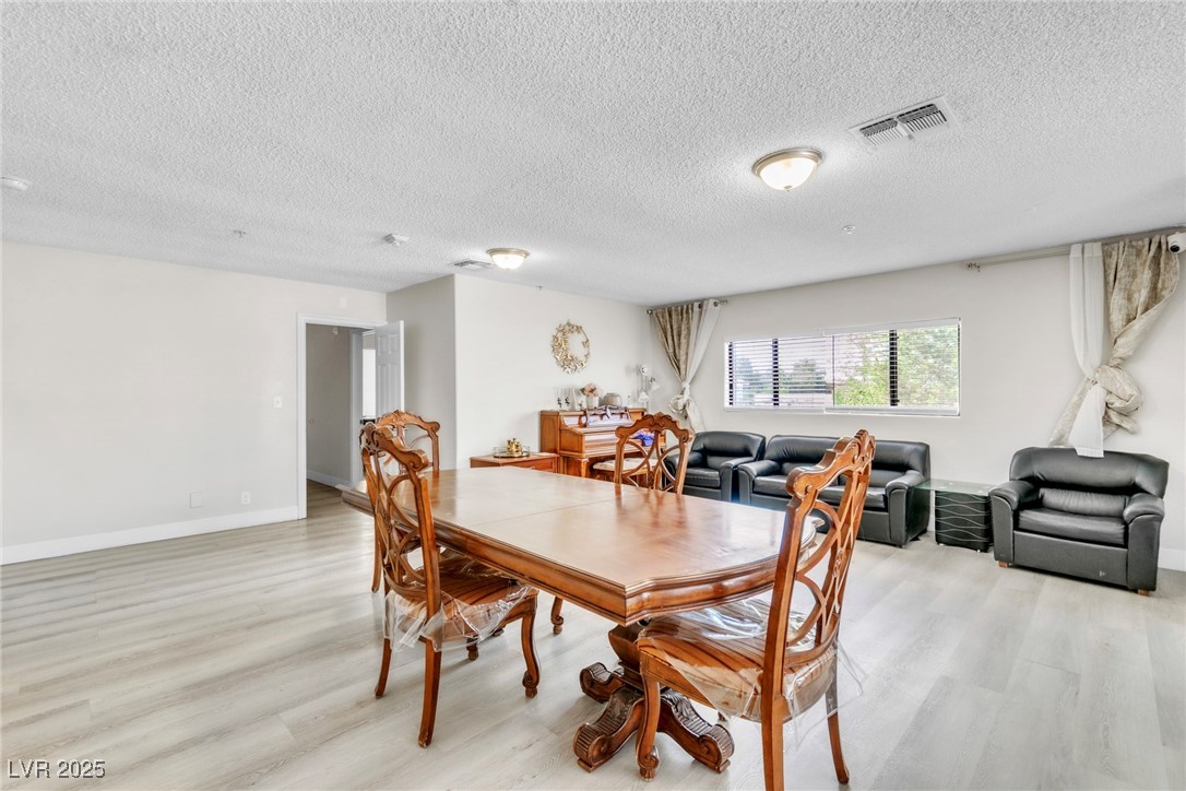 465 East Robindale Road Las Vegas, NV 89123 - Photo 4 of 32 Dining area with light wood-type flooring and a te