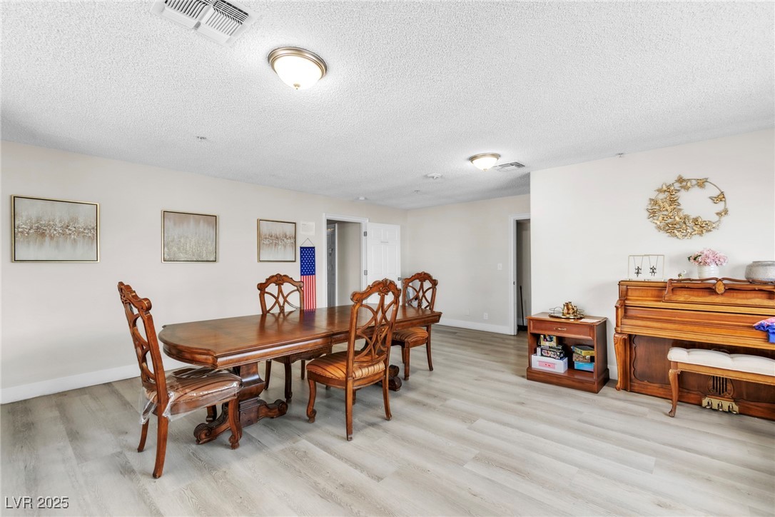465 East Robindale Road Las Vegas, NV 89123 - Photo 5 of 32 Dining area featuring light wood-type flooring and