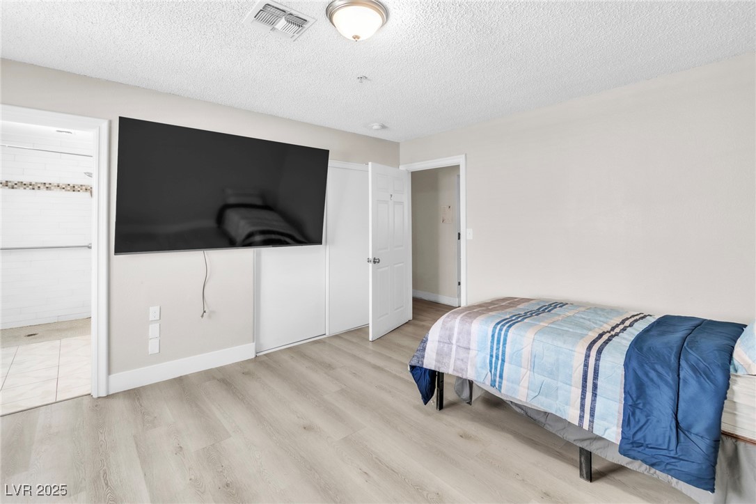 465 East Robindale Road Las Vegas, NV 89123 - Photo 7 of 32 Bedroom with wood finished floors, a textured ceil