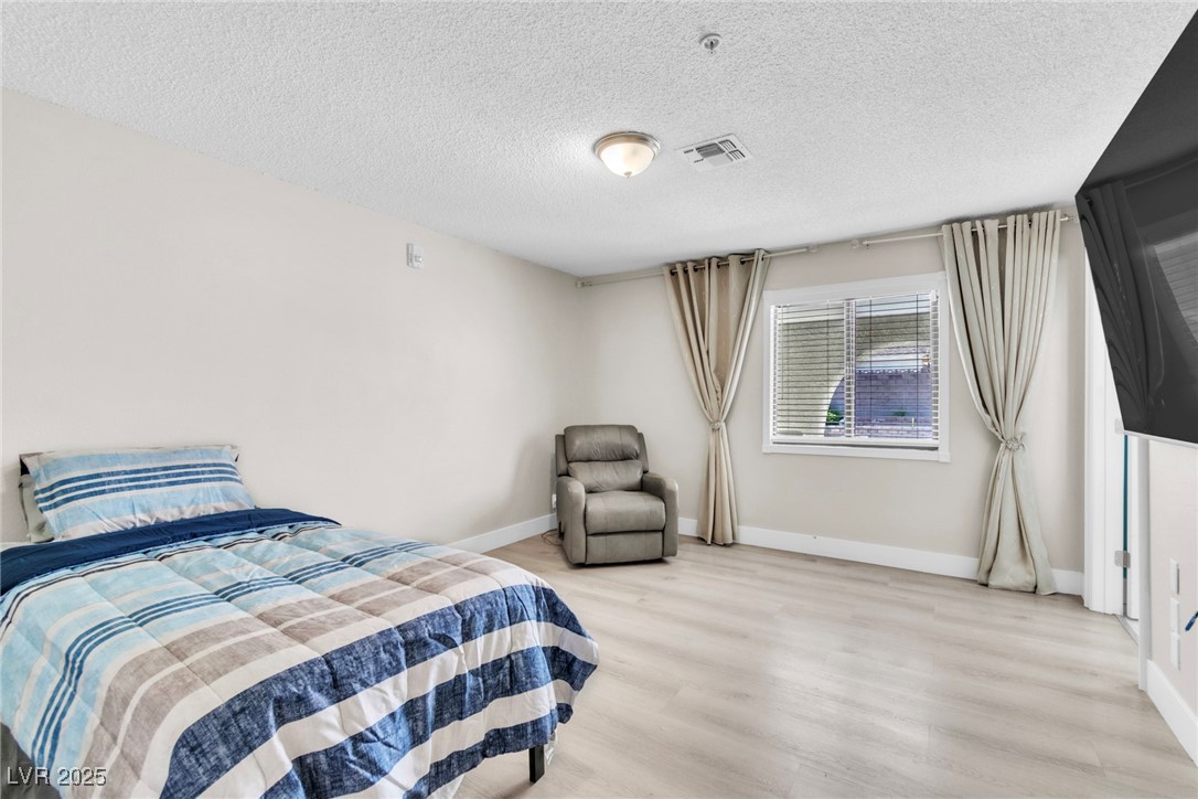 465 East Robindale Road Las Vegas, NV 89123 - Photo 8 of 32 Bedroom featuring light wood-style flooring and a