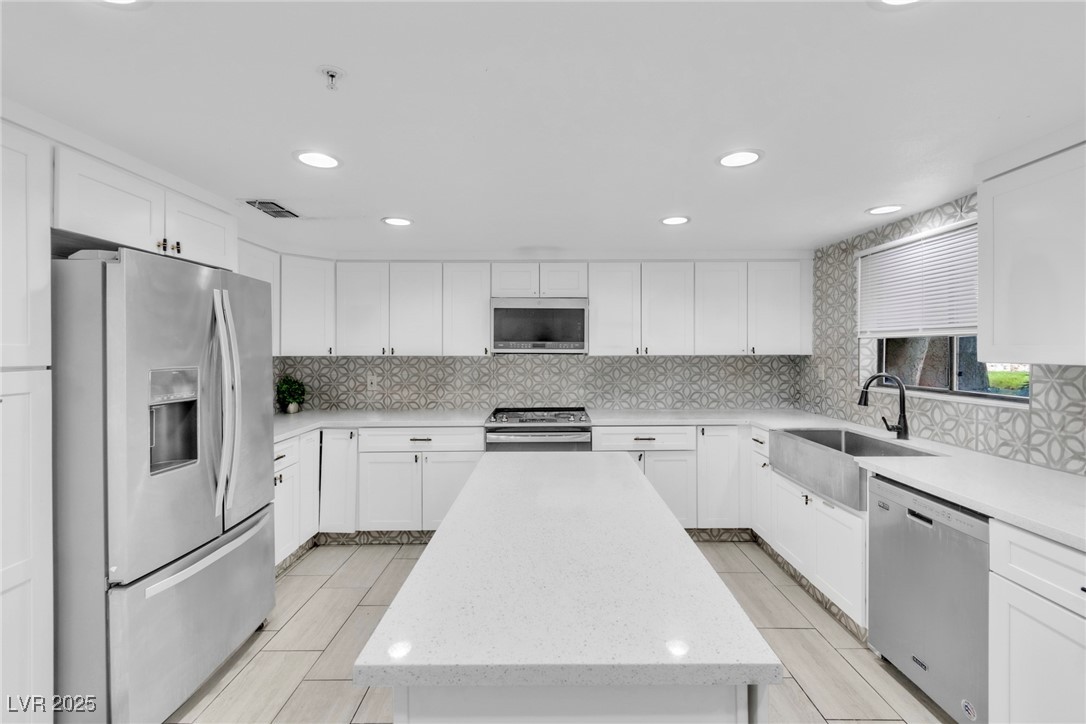 465 East Robindale Road Las Vegas, NV 89123 - Photo 9 of 32 Kitchen with stainless steel appliances, a center