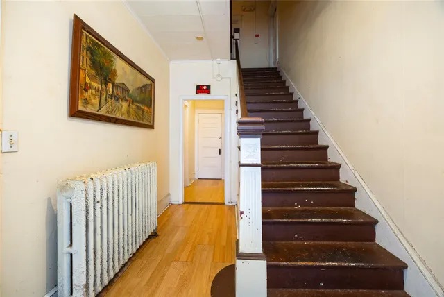 a view of entryway and hall with wooden floor
