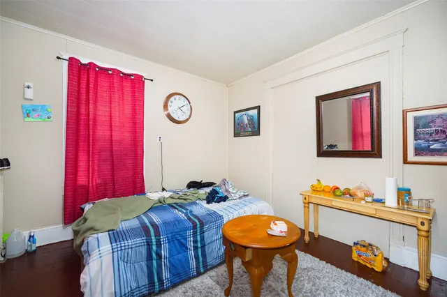 a bedroom with bed and a chandelier