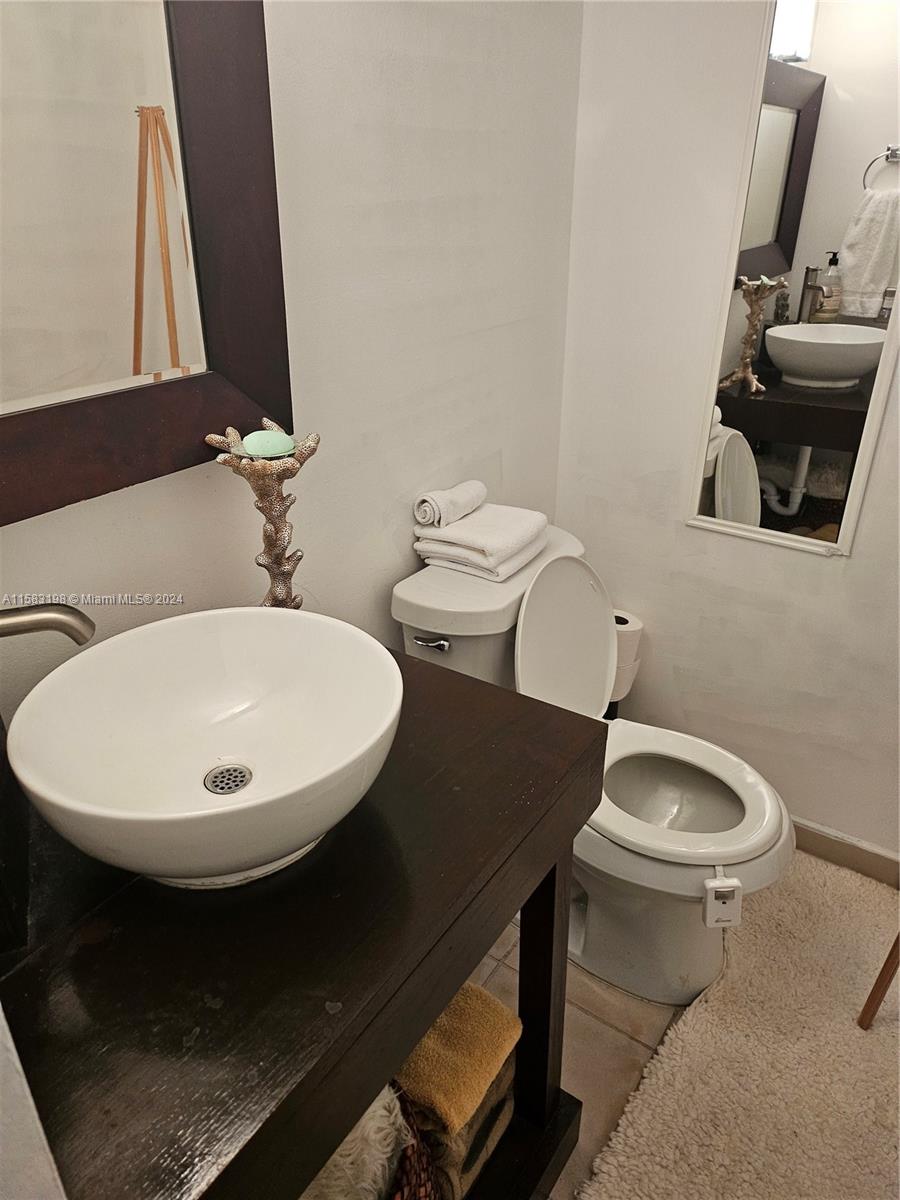 1605 Bay Road, Unit 406 Miami Beach, FL 33139 - Photo 12 of 31 a bathroom with a sink and a mirror
