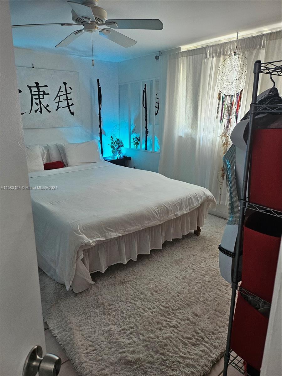 1605 Bay Road, Unit 406 Miami Beach, FL 33139 - Photo 13 of 31 a bedroom with a bed and a mirror