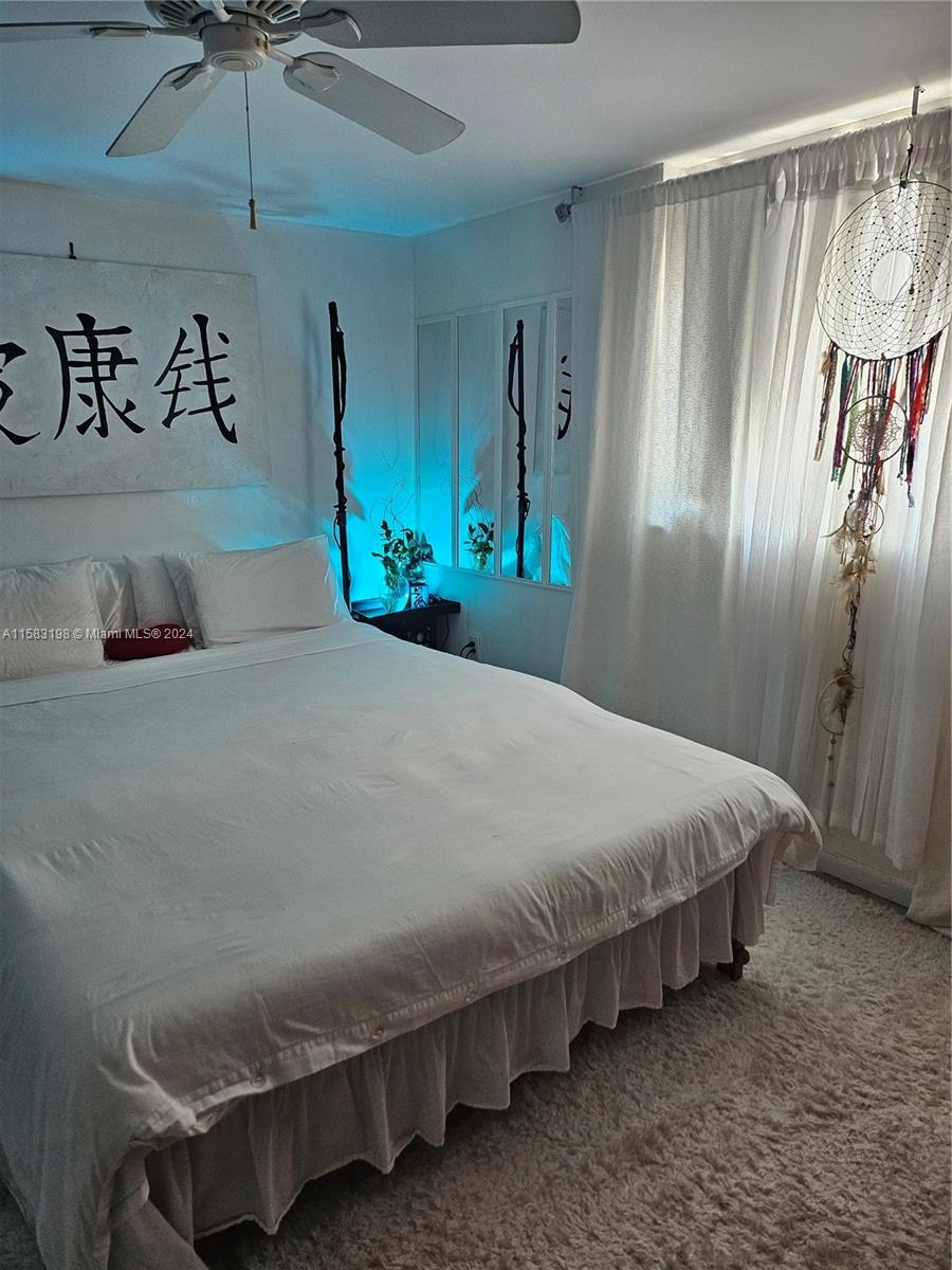 1605 Bay Road, Unit 406 Miami Beach, FL 33139 - Photo 14 of 31 a bedroom with a bed and a table