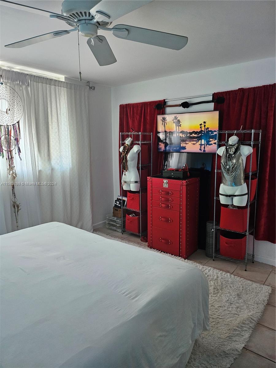 1605 Bay Road, Unit 406 Miami Beach, FL 33139 - Photo 16 of 31 a bed room with a bed and a store