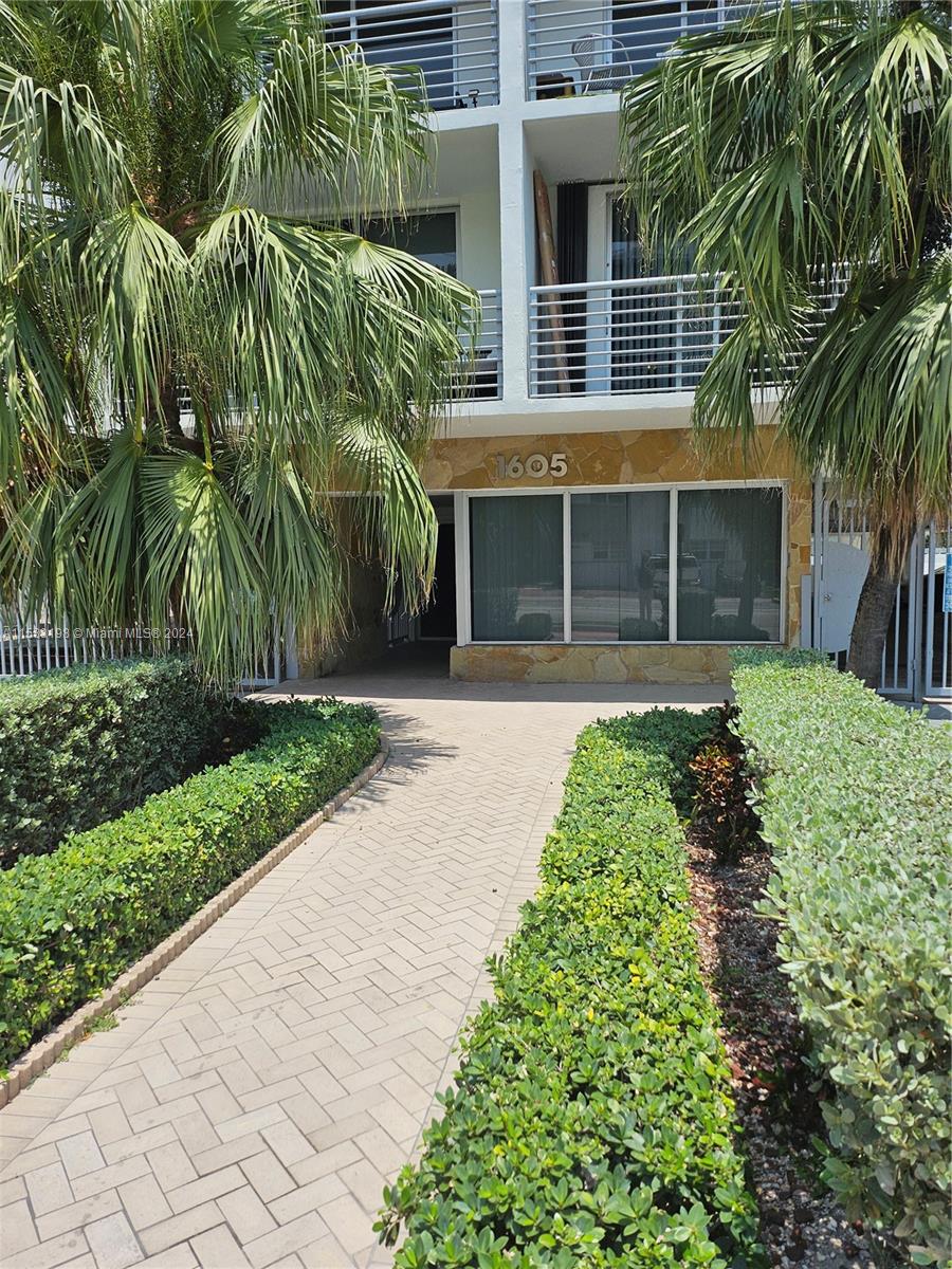 1605 Bay Road, Unit 406 Miami Beach, FL 33139 - Photo 2 of 31 a front view of a house with a yard and potted plants
