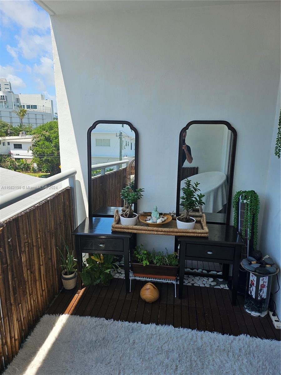 1605 Bay Road, Unit 406 Miami Beach, FL 33139 - Photo 28 of 31 a room with furniture mirror and wooden floor