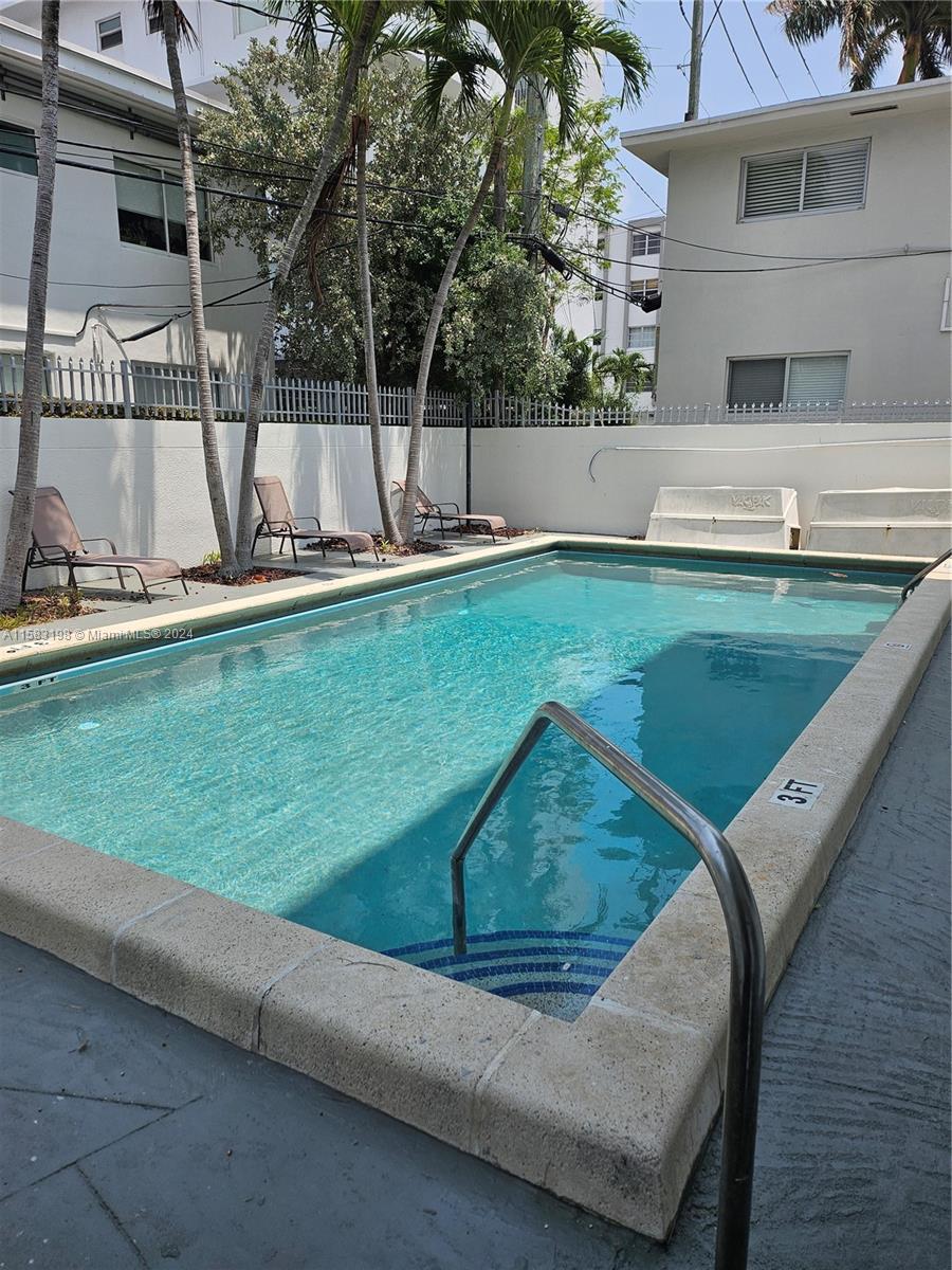 1605 Bay Road, Unit 406 Miami Beach, FL 33139 - Photo 29 of 31 a view of a swimming pool with a patio