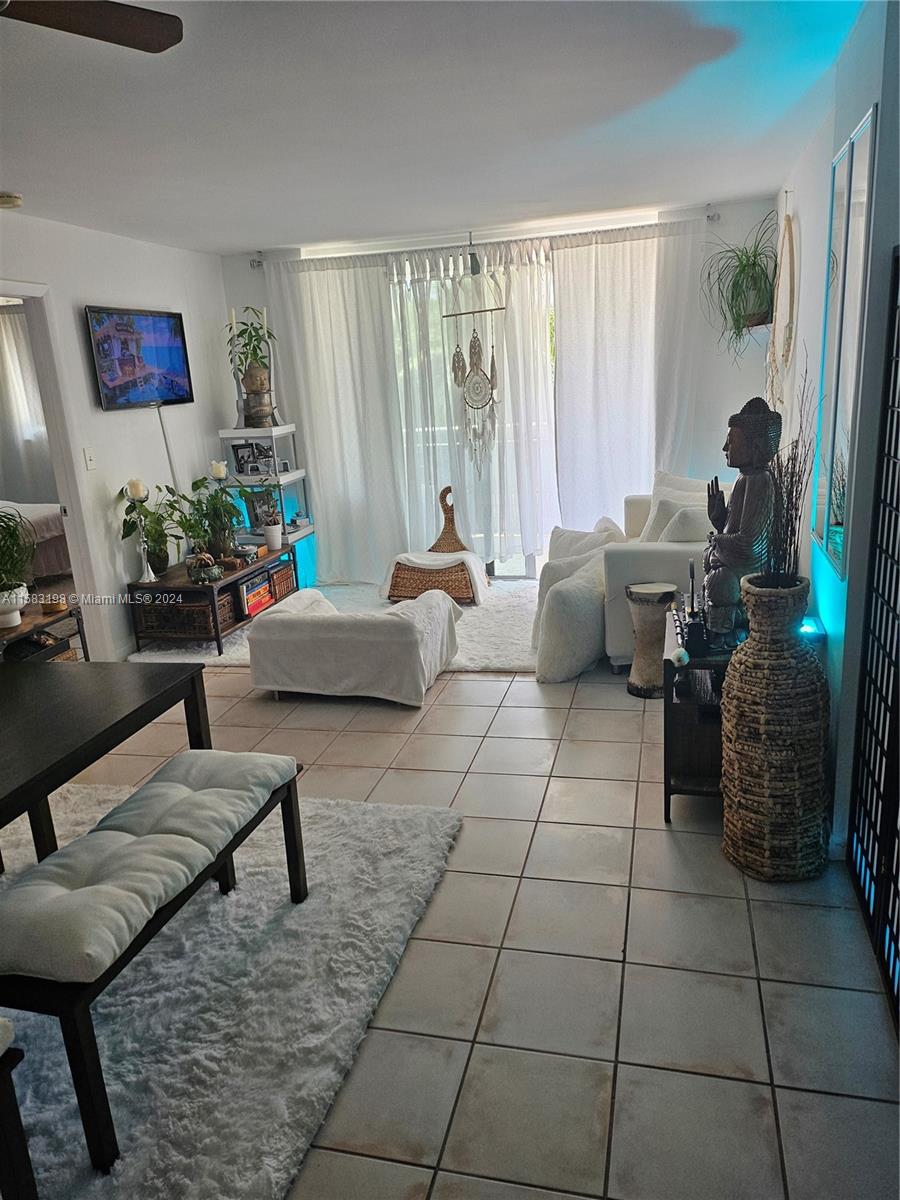 1605 Bay Road, Unit 406 Miami Beach, FL 33139 - Photo 3 of 31 a living room with furniture and a large window