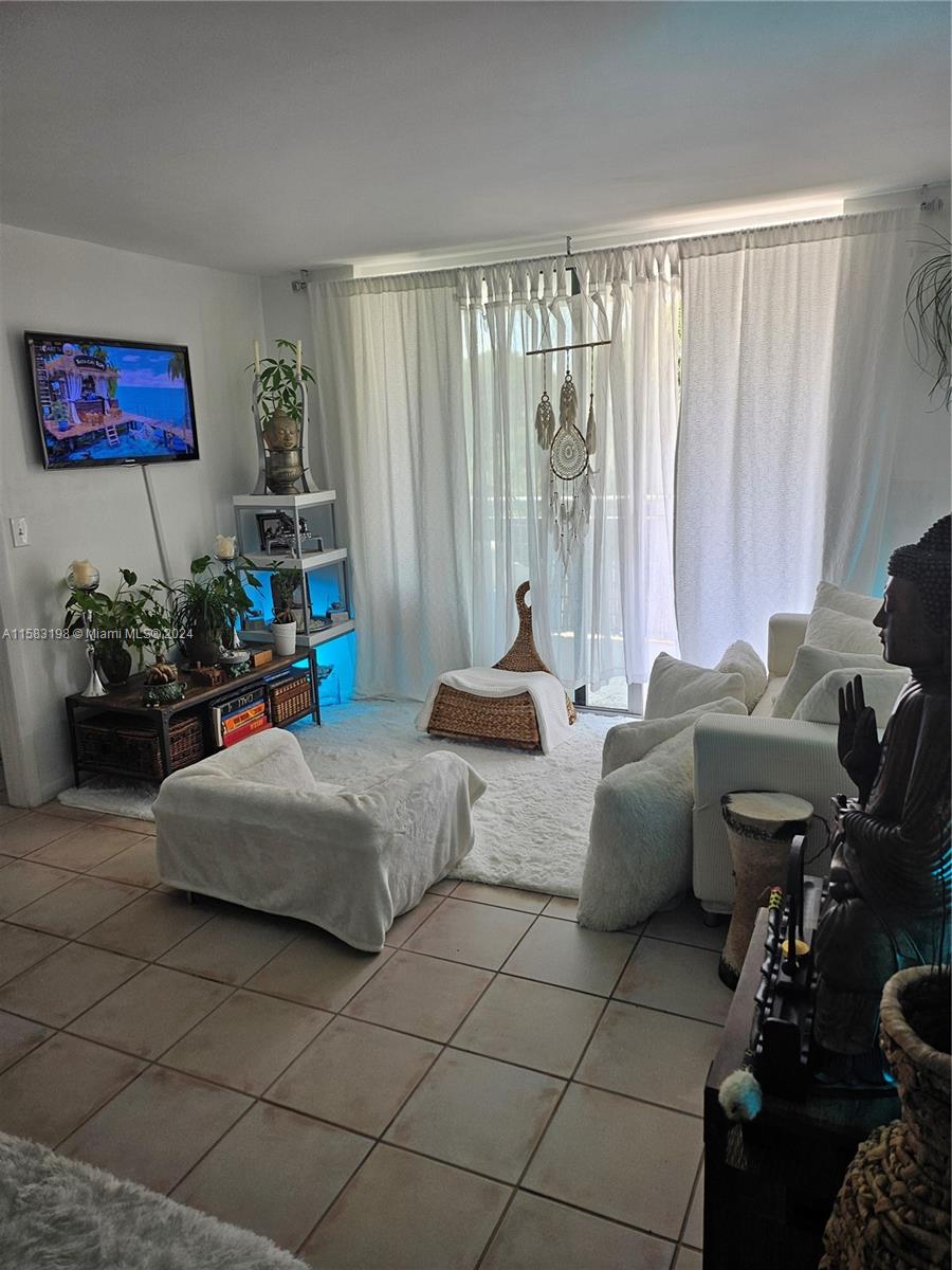 1605 Bay Road, Unit 406 Miami Beach, FL 33139 - Photo 4 of 31 a living room with furniture and a large window