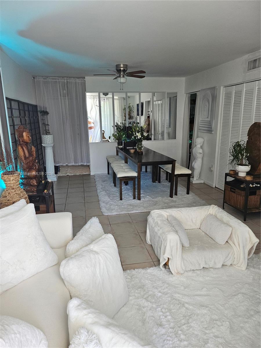 1605 Bay Road, Unit 406 Miami Beach, FL 33139 - Photo 6 of 31 a living room with furniture and a window