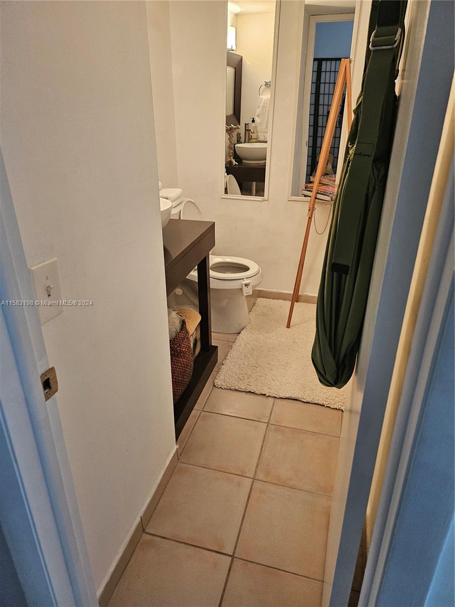1605 Bay Road, Unit 406 Miami Beach, FL 33139 - Photo 10 of 31 a bathroom with a sink toilet and shower