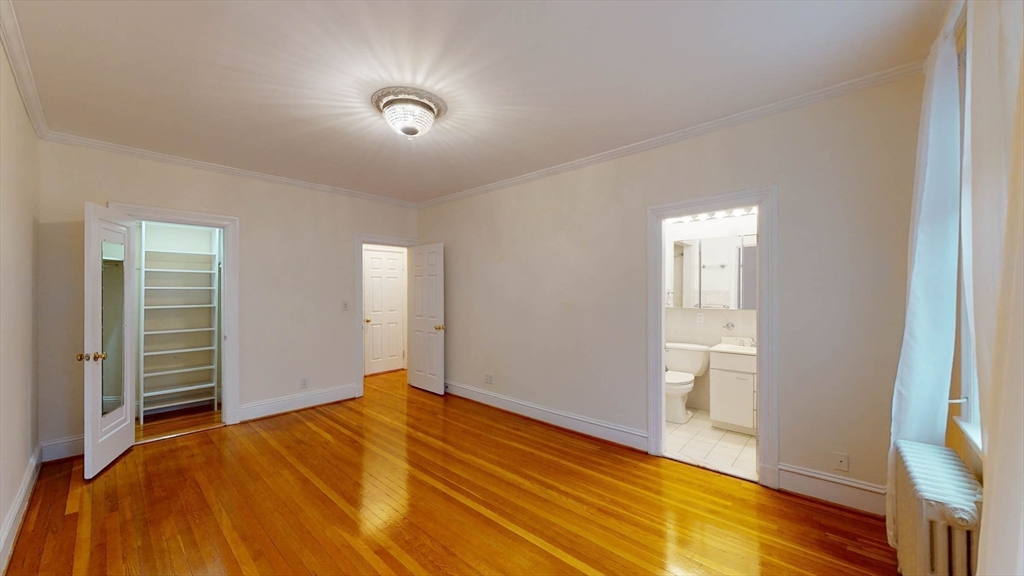 311 Tappan Street, Unit 3 Brookline, MA 02445 - Photo 29 of 35 a view of empty room with wooden floor and fan