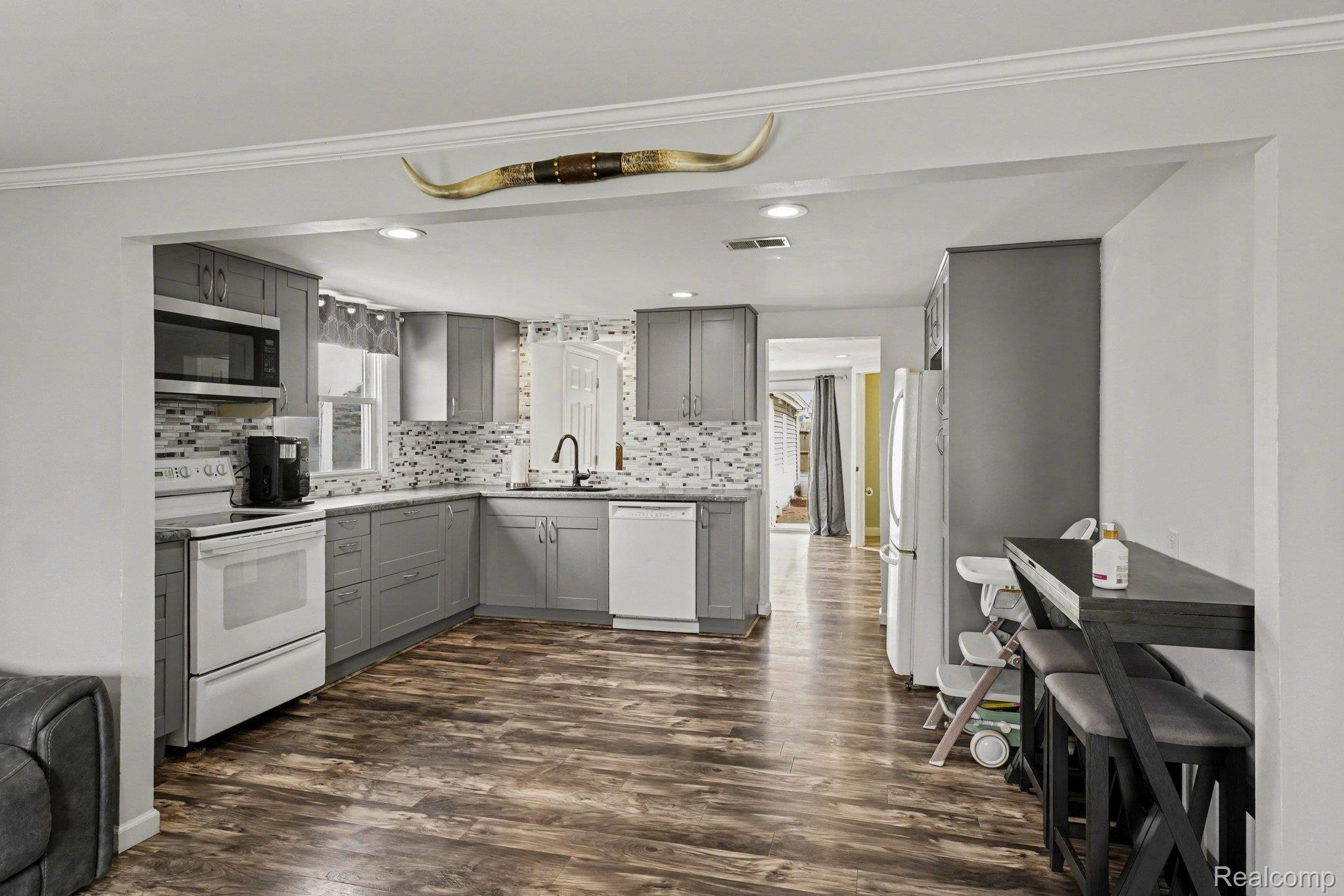 16485 Jennings Road Fenton, MI 48430 - Photo 15 of 27 Kitchen featuring gray cabinets, white appliances, dark wood-type flooring, light countertops, and recessed lighting