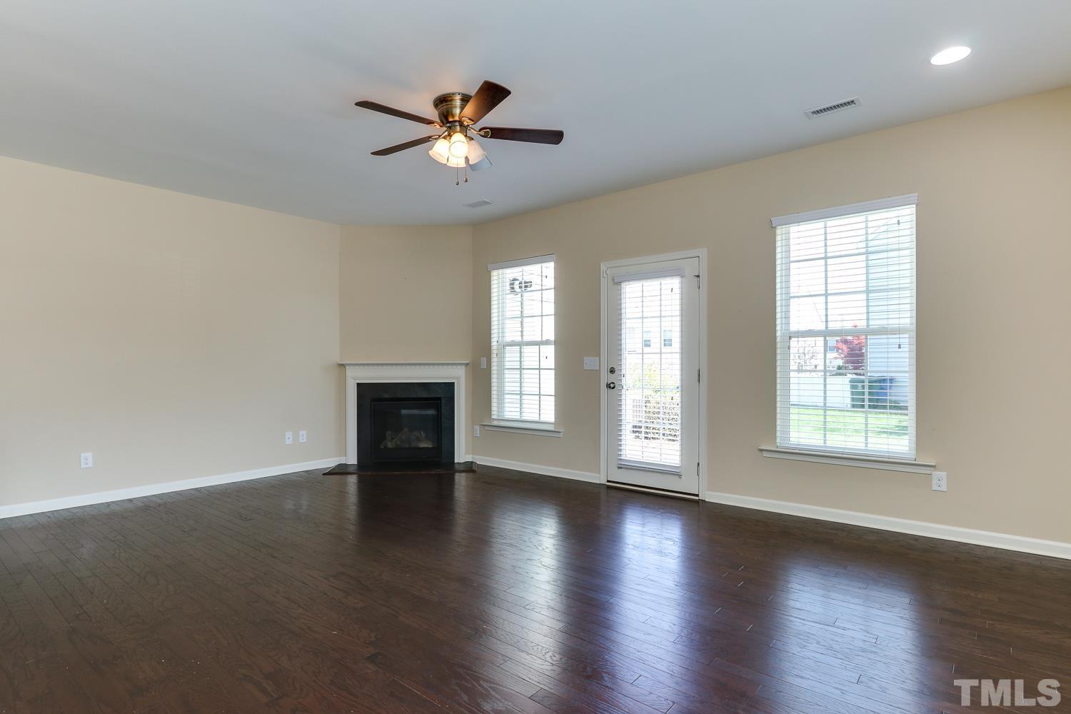 949 Consortium Drive Raleigh, NC 27603 - Photo 7 of 23 a view of an empty room with wooden floor and a window