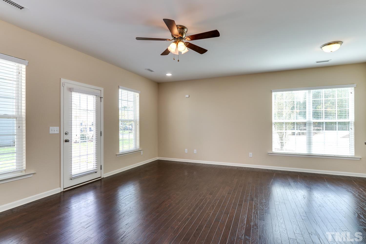 949 Consortium Drive Raleigh, NC 27603 - Photo 9 of 23 a view of an empty room with wooden floor and a window