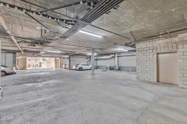 a view of a big room with wooden floor and windows