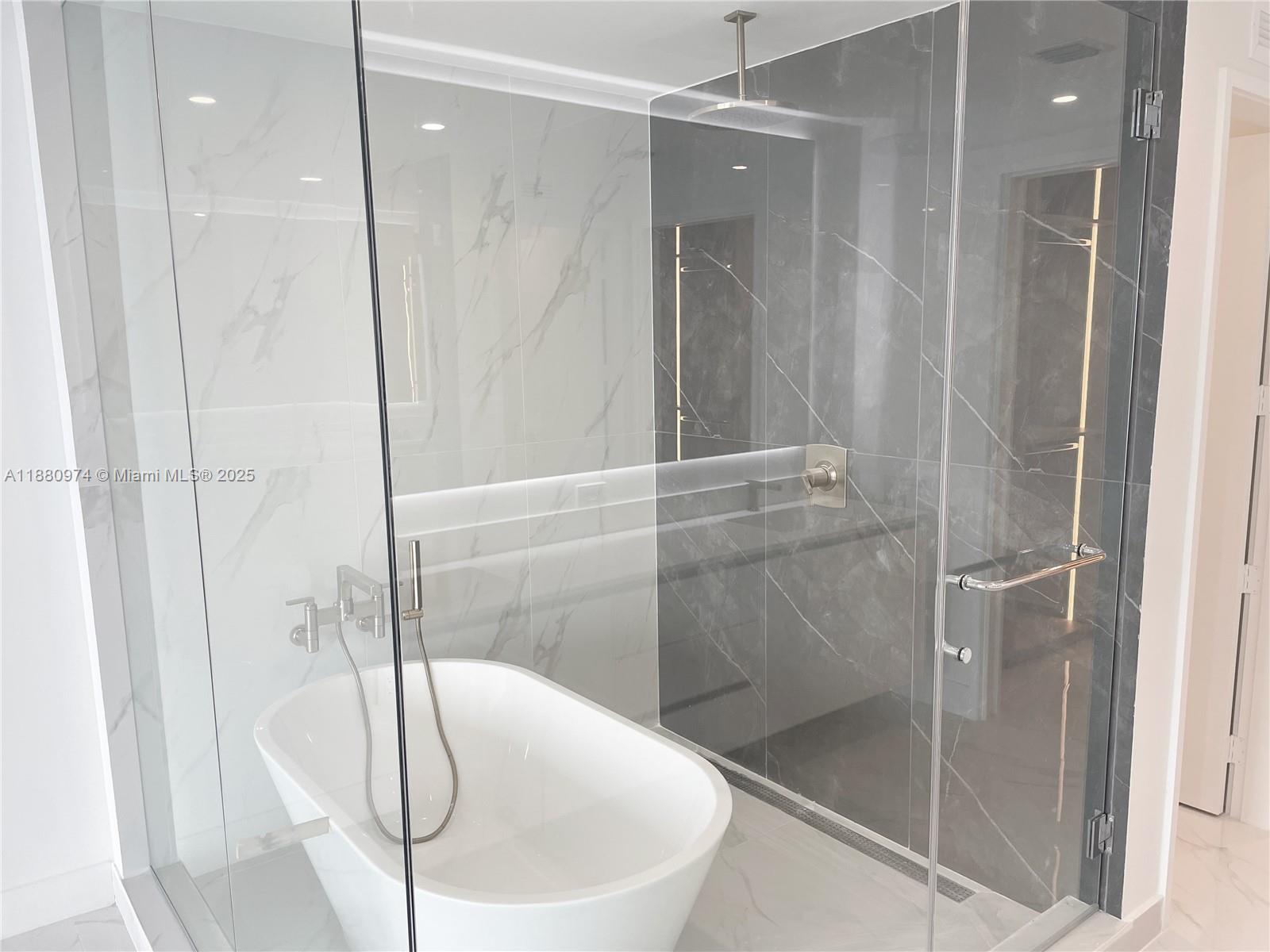 700 Northeast 24th Street, Unit 4604 Miami, FL 33137 - Photo 13 of 41 a bathroom with a bathtub and a shower