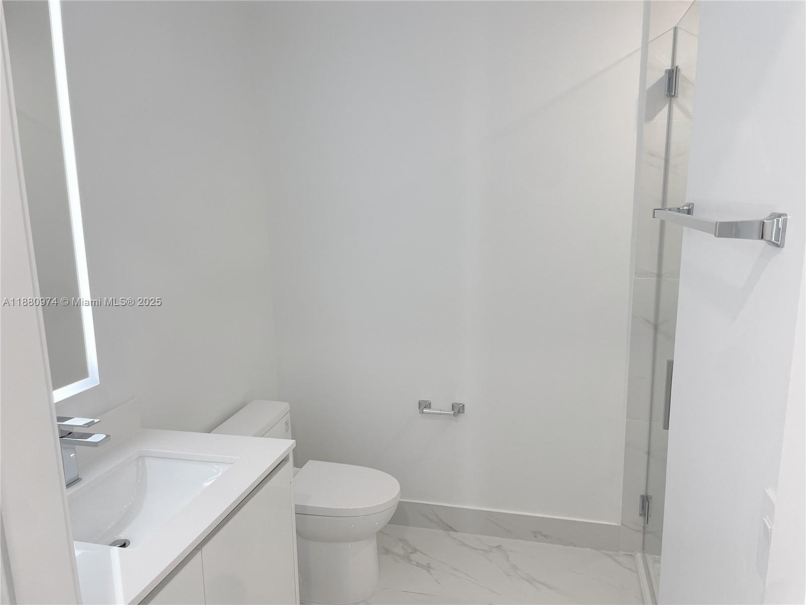 700 Northeast 24th Street, Unit 4604 Miami, FL 33137 - Photo 6 of 41 a white toilet sitting next to a bathroom sink