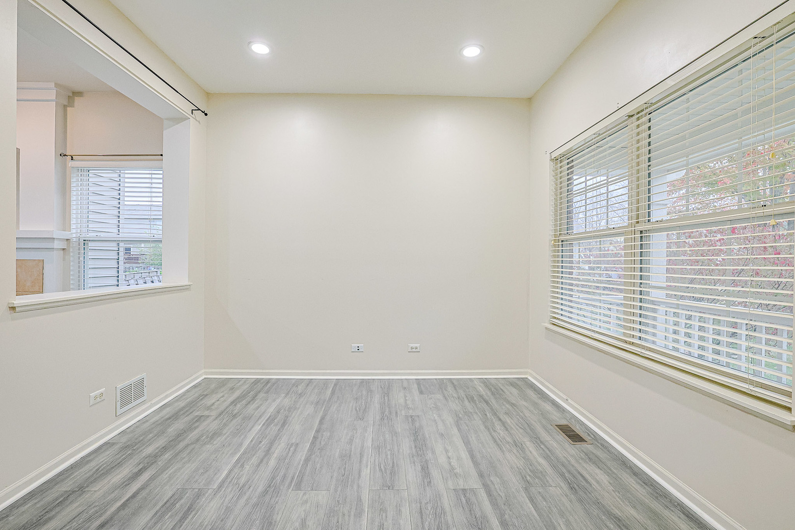 204 Aspen Circle Gilberts, IL 60136 - Photo 4 of 25 a view of an empty room with wooden floor and a window