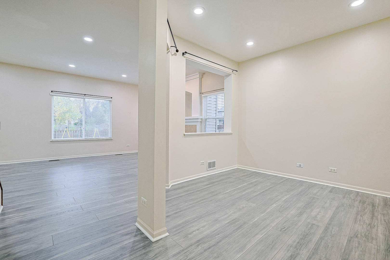 204 Aspen Circle Gilberts, IL 60136 - Photo 6 of 25 an empty room with wooden floor and windows