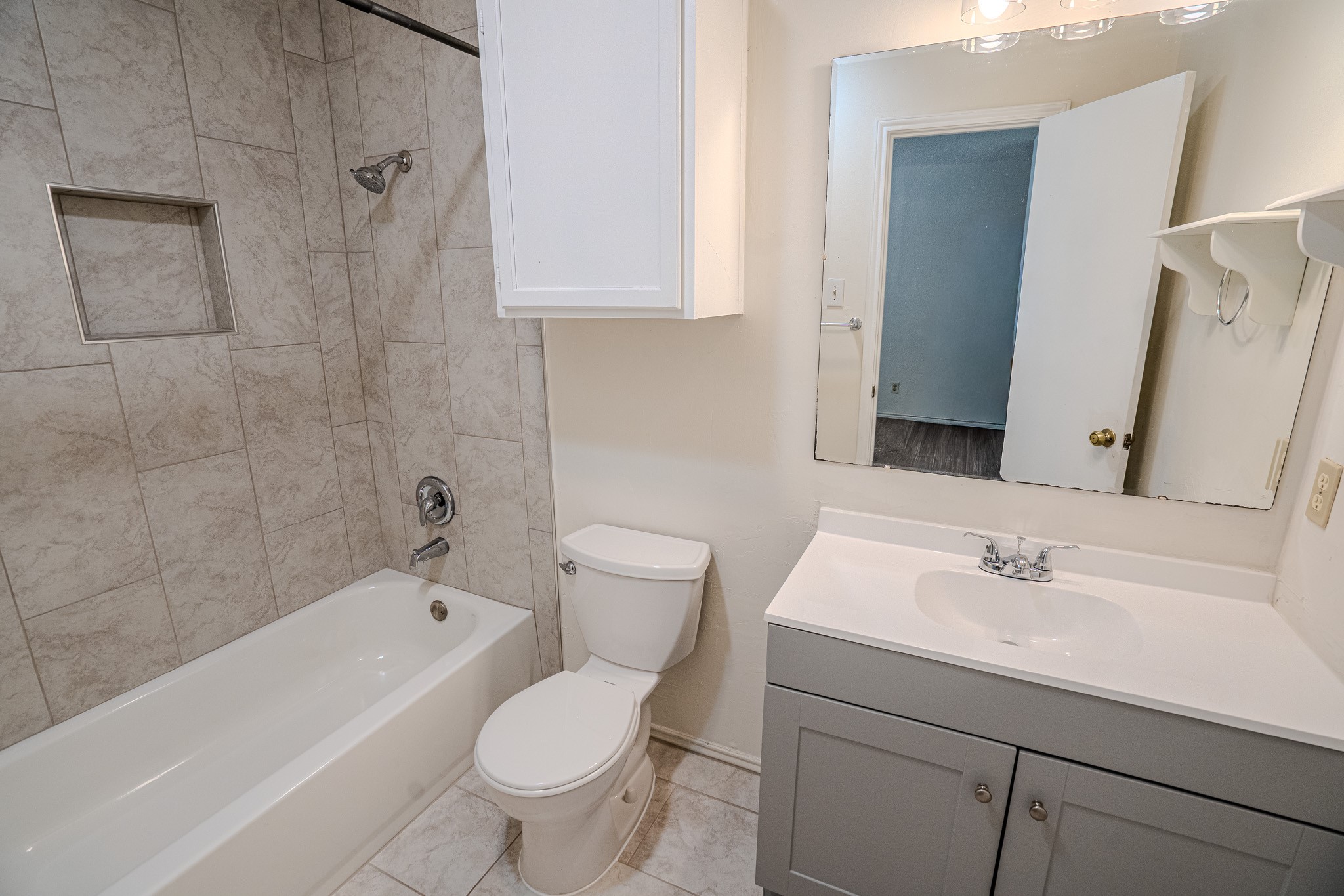 517 Cutty Trail, Unit B Lakeway, TX 78734 - Photo 8 of 16 Modern full bathroom features a vanity with ample storage and a tiled shower-tub combination.