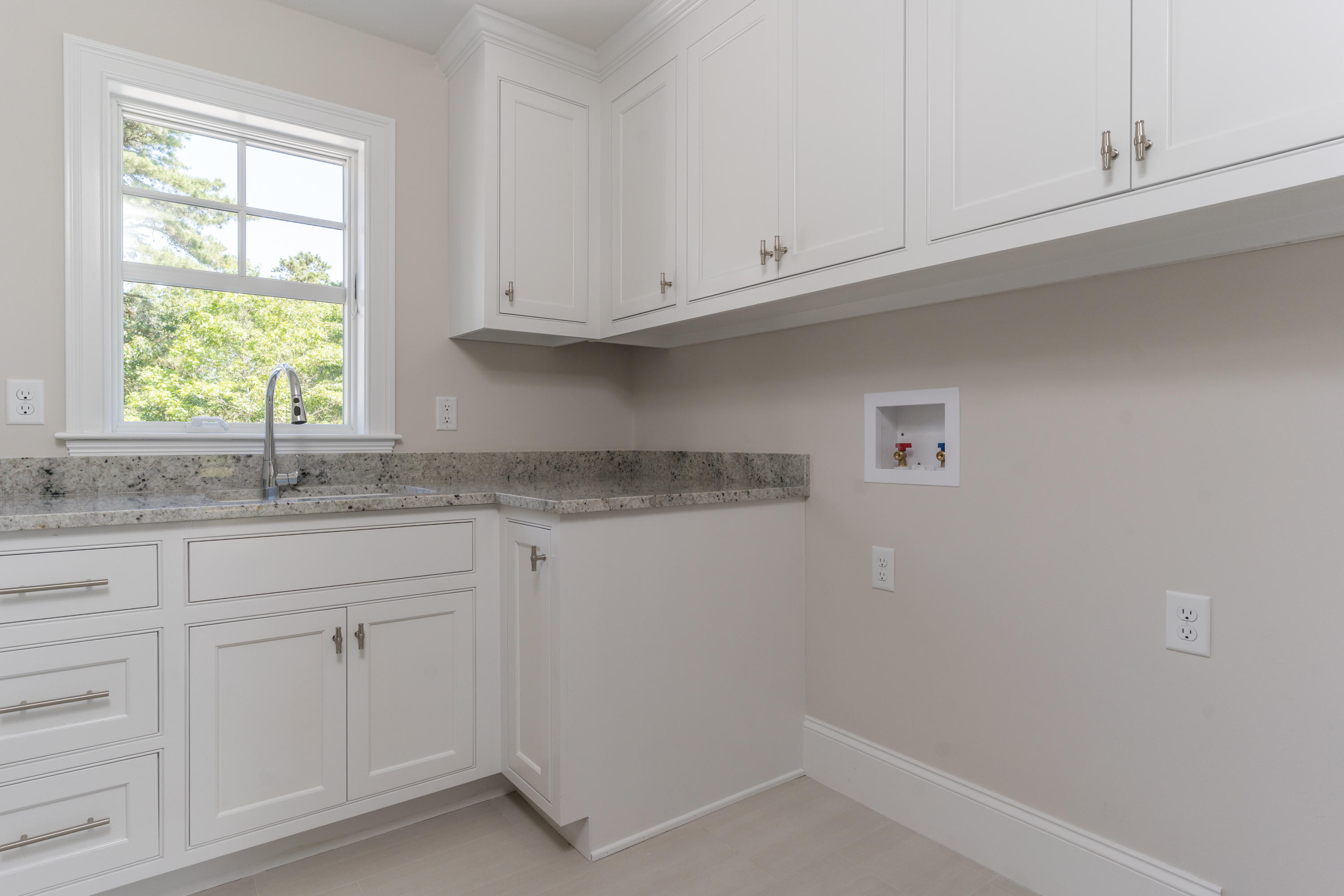 14 Crocker Rise Road Harwich, MA 02645 - Photo 19 of 38 a kitchen with white cabinets and a window