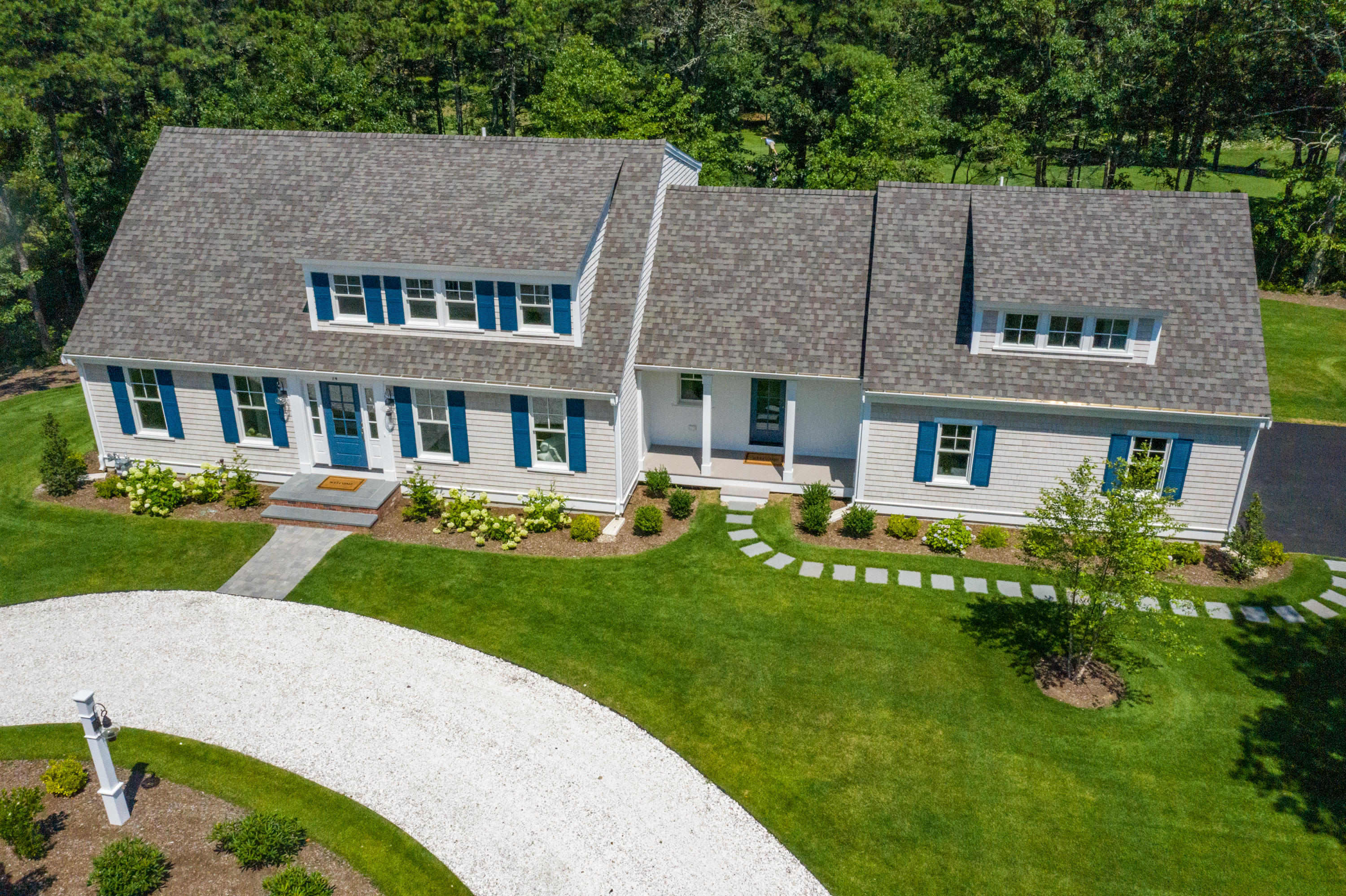 14 Crocker Rise Road Harwich, MA 02645 - Photo 30 of 38 a front view of a house with a yard table and chairs