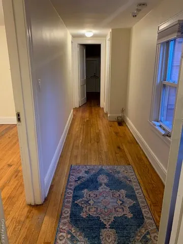 a view of an empty room and wooden floor