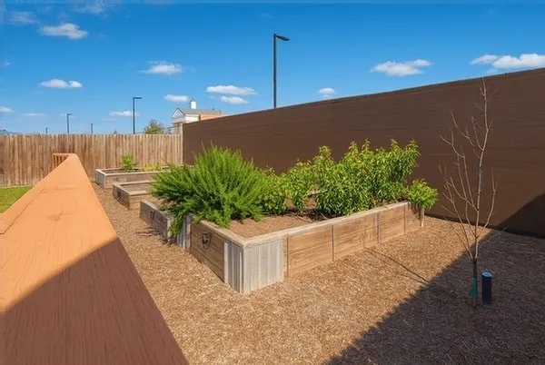 a view of a house with a backyard and plants