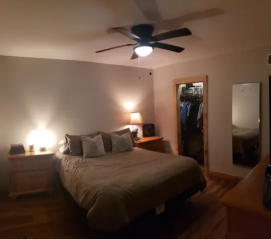 a bedroom with a bed and a lamp