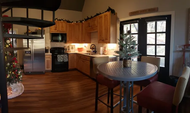 a kitchen with a table chairs stove and cabinets
