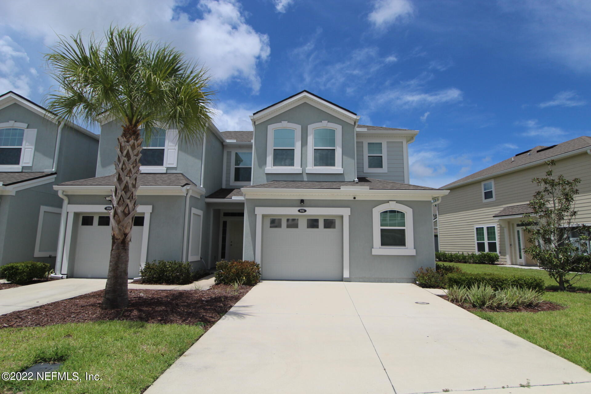 552 Richmond Drive St. Johns, FL 32259 - Photo 2 of 50 a front view of a house with a yard and garage