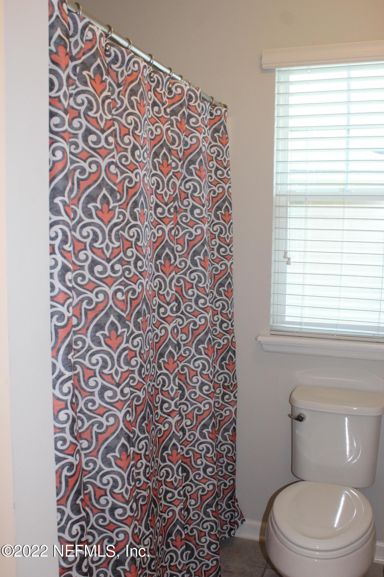 552 Richmond Drive St. Johns, FL 32259 - Photo 38 of 50 a white toilet sitting next to a shower curtain