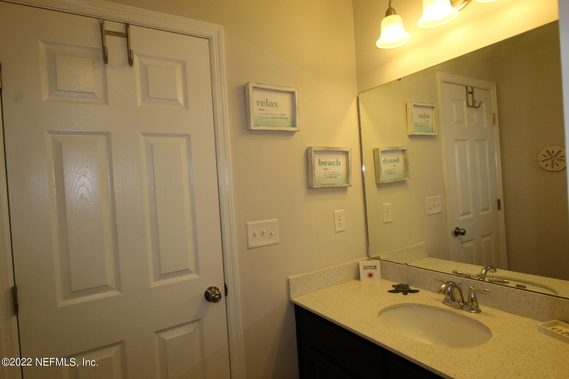 552 Richmond Drive St. Johns, FL 32259 - Photo 40 of 50 a bathroom with a shower sink vanity and mirror