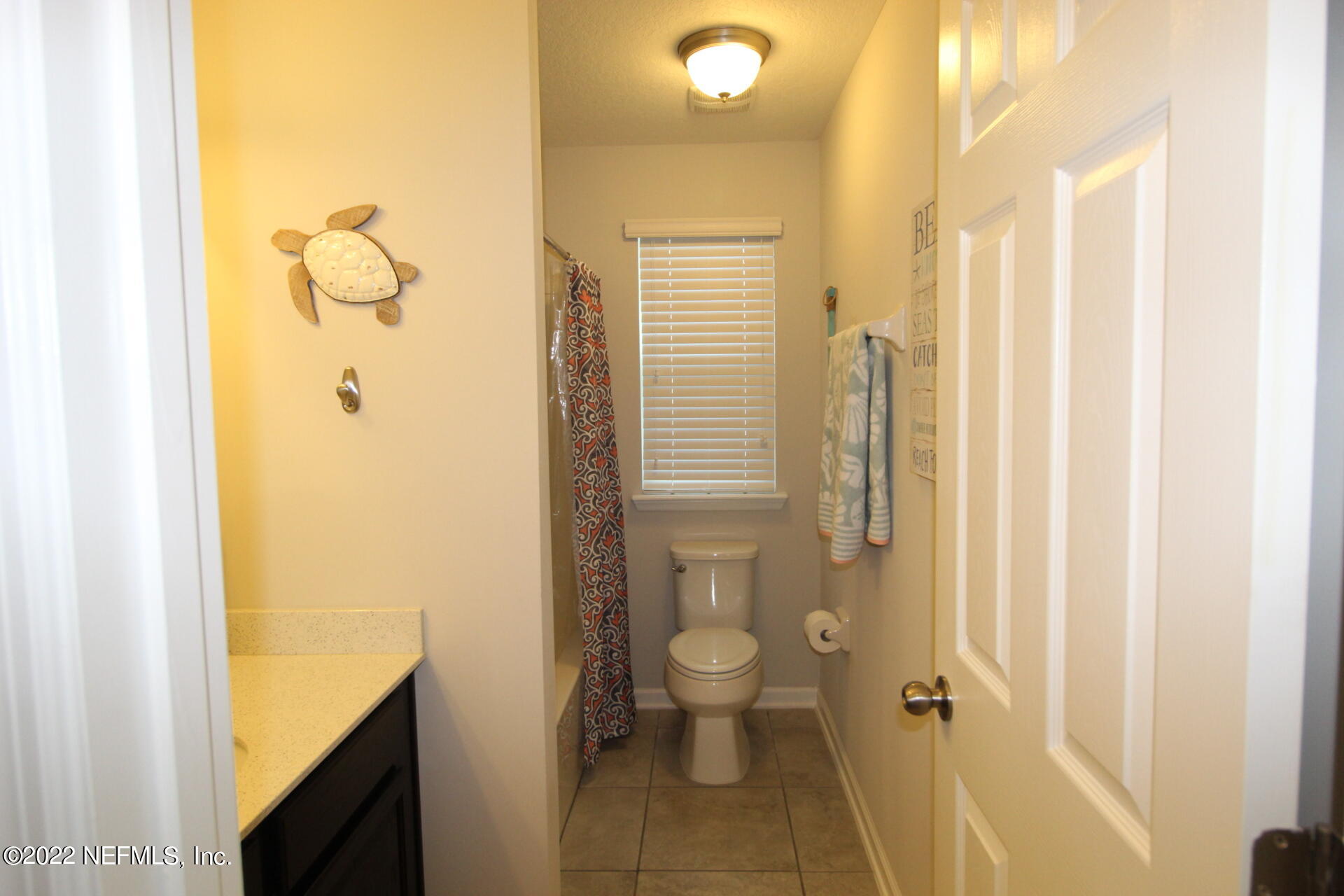 552 Richmond Drive St. Johns, FL 32259 - Photo 41 of 50 a bathroom with a granite countertop sink a toilet and shower
