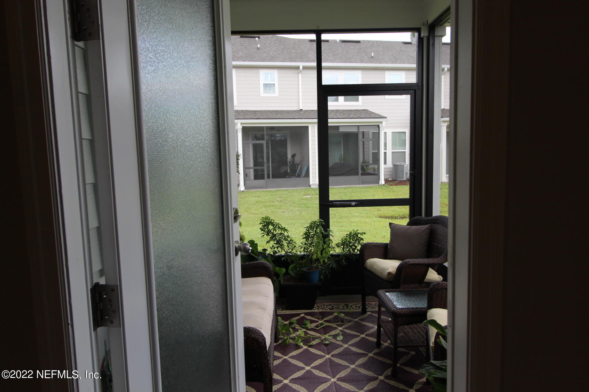 552 Richmond Drive St. Johns, FL 32259 - Photo 8 of 50 a view of a porch with chairs and potted plants next to a window