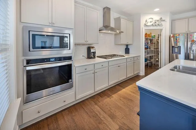 a kitchen with stainless steel appliances kitchen island wooden cabinets and granite counter tops