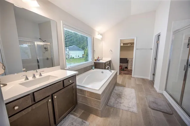 a bathroom with a sink a mirror and a bathtub