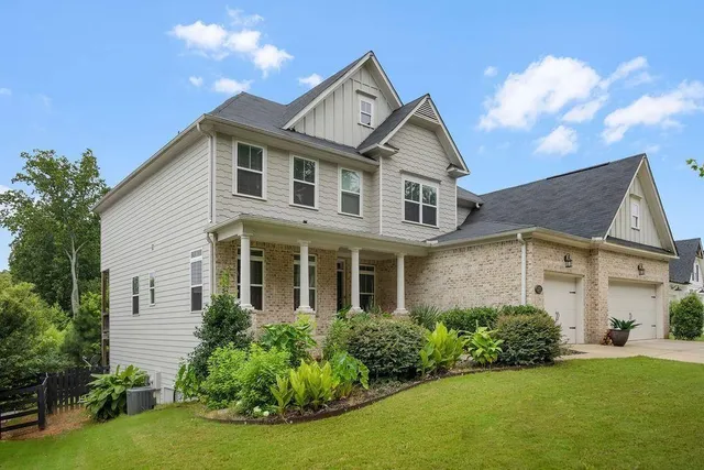 a front view of a house with a garden