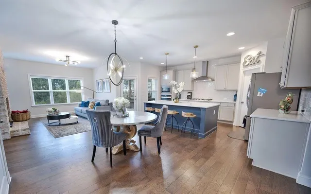 a view of a dining room with furniture window and wooden floor