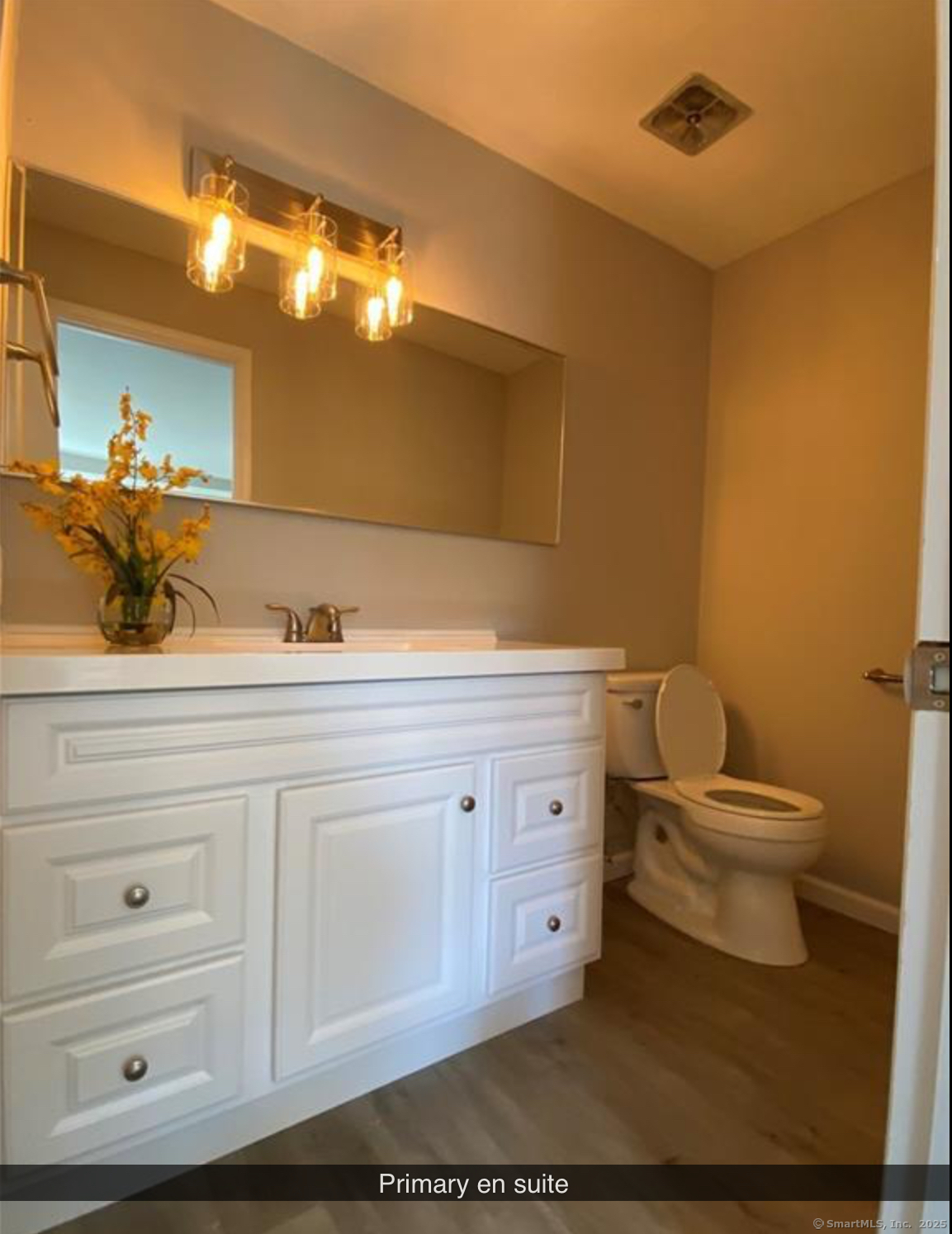 99 Brittany Farms Road, Unit F New Britain, CT 06053 - Photo 15 of 31 a bathroom with a toilet a sink and mirror