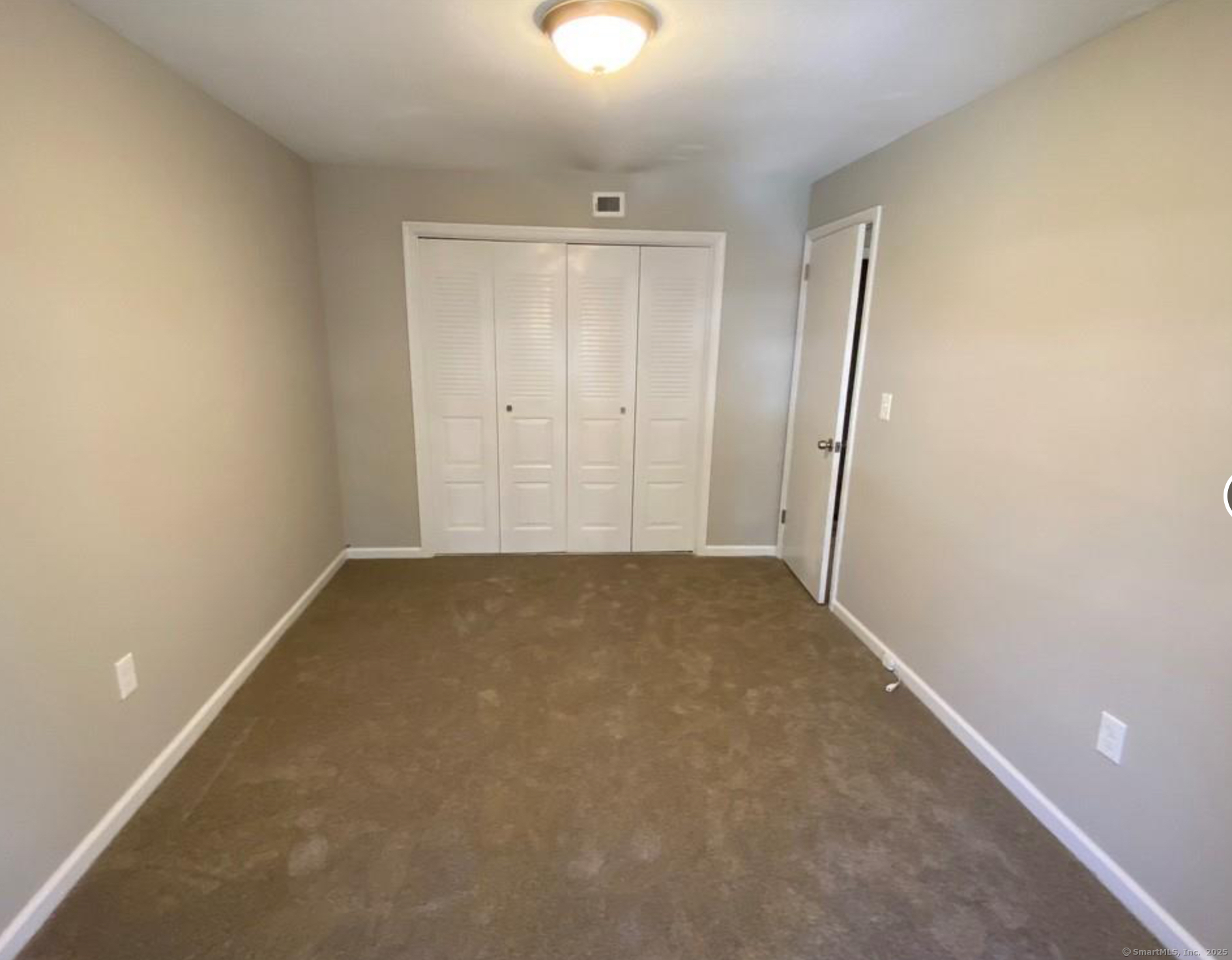 99 Brittany Farms Road, Unit F New Britain, CT 06053 - Photo 17 of 31 an empty room with closet area