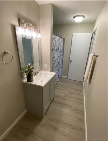 a bathroom with a double vanity sink mirror and tub