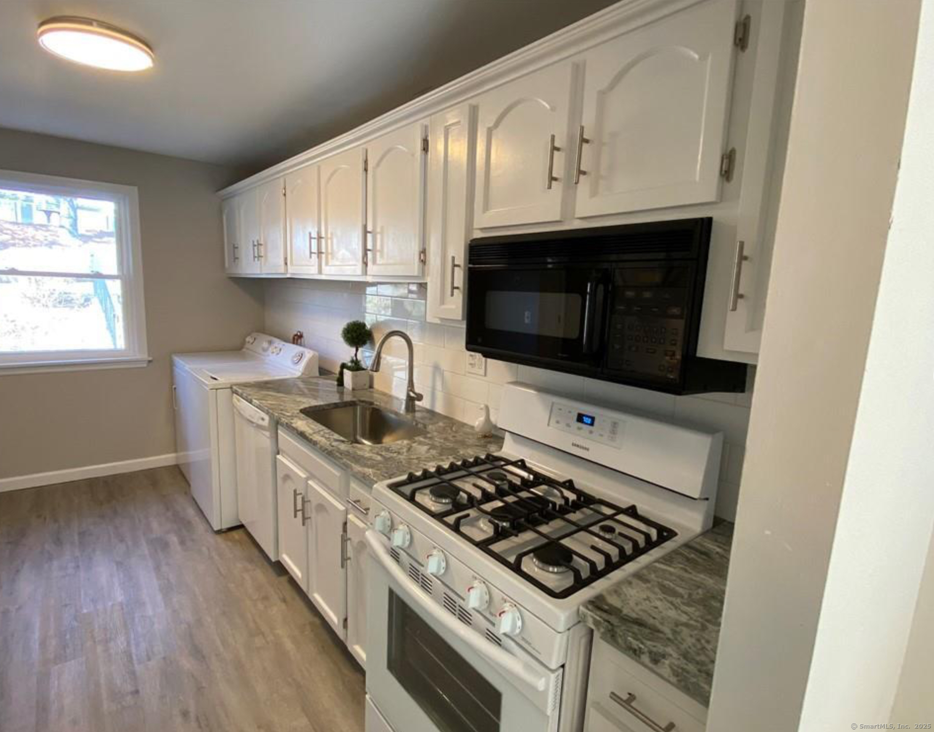 99 Brittany Farms Road, Unit F New Britain, CT 06053 - Photo 5 of 31 a kitchen with stainless steel appliances a stove a microwave a sink and cabinets