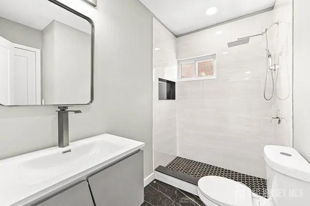 a view of a hallway with wooden floor and stairs
