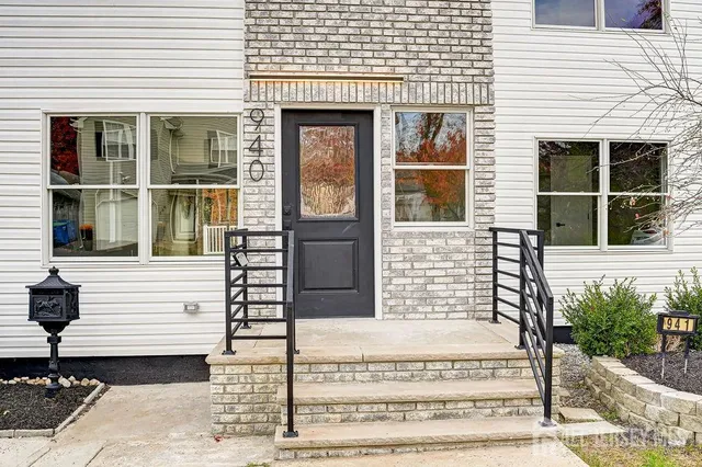 a view of an entryway with wooden floor and door